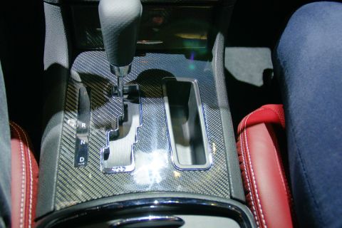 1993 Ford Taurus - Center console detail with gear shifter, carbon fiber trim, and red seats.