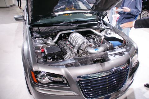 1993 Ford Taurus - The engine bay of a Chrysler 300 SRT8 is displayed with the hood open, revealing its powerful V8 engine.