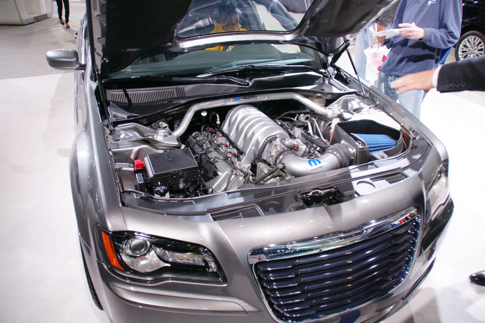 Chrysler 300 SRT8 with hood open showing engine and intake. Grille has SRT8 badge