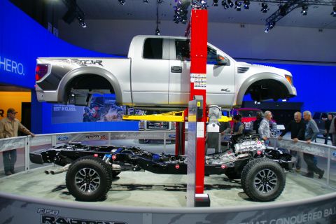 1993 Ford Taurus - A Ford F-150 Raptor is displayed with its body separated from the chassis to show the internal components.