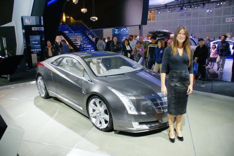 1993 Ford Taurus - A woman poses next to a concept car at the LA Auto Show.