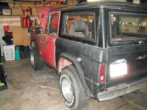 1991 Ford Bronco - This Ford Bronco is parked in a garage with its hood open, showing a two-tone paint scheme.