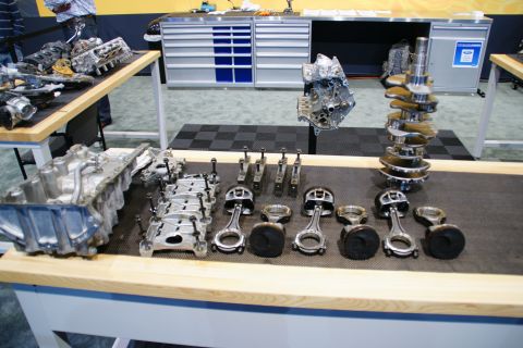 1993 Ford Taurus - A display of various internal engine components, including a crankshaft and pistons with connecting rods.