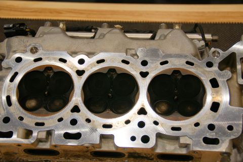 1993 Ford Taurus - Close-up view of an engine cylinder head, revealing the internal structure with valves and combustion chambers.