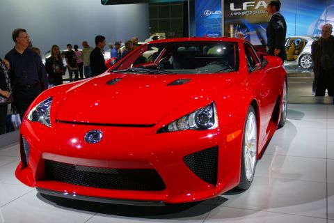 1993 Ford Taurus - A bright red Lexus LFA is displayed at an auto show.
