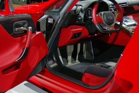 1993 Ford Taurus - The interior of a red sports car features red leather seats, a carbon fiber steering wheel, and a red dashboard.