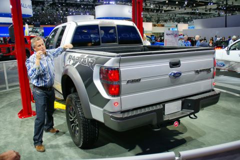 1993 Ford Taurus - Silver Ford F-150 Raptor pickup truck on display at an auto show.