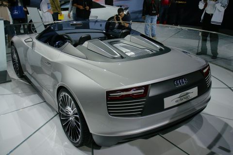 1993 Ford Taurus - A silver convertible concept car, identified by its 'e-tron' badge, is displayed at an auto show.