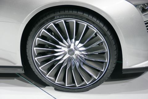 1993 Ford Taurus - Close-up of a silver Audi wheel a complex spoke design and Dunlop branding on the tire.