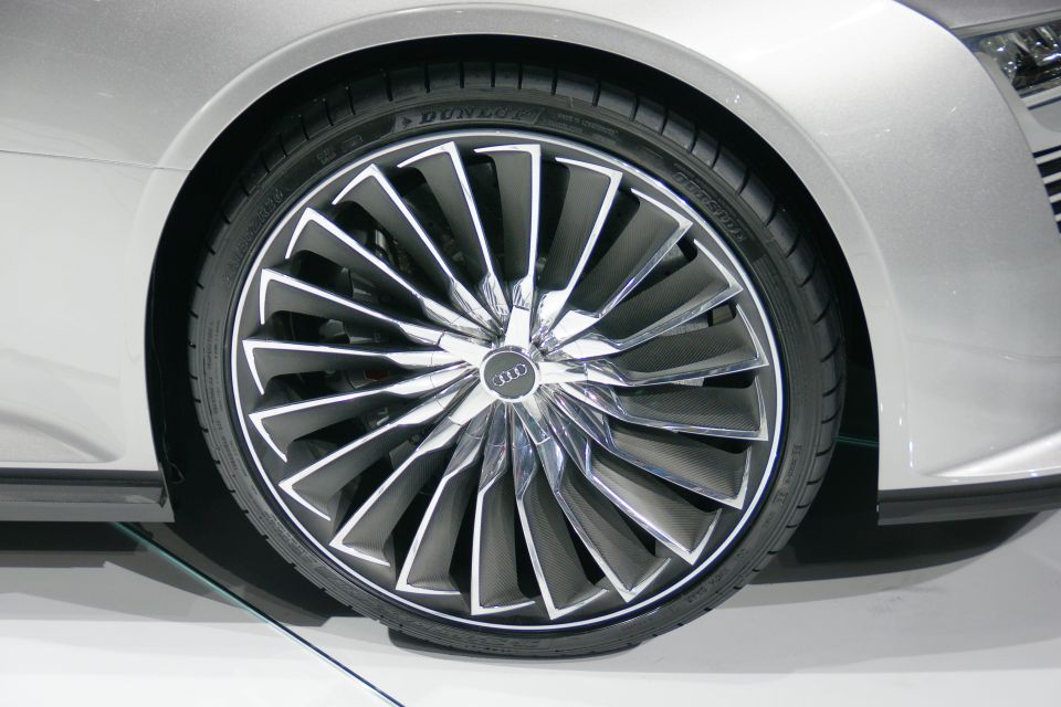 Silver Audi wheel with intricate spokes and Dunlop tire