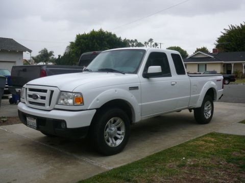 1988 Ford Bronco - A white Ford Ranger pickup truck is parked in a residential driveway.