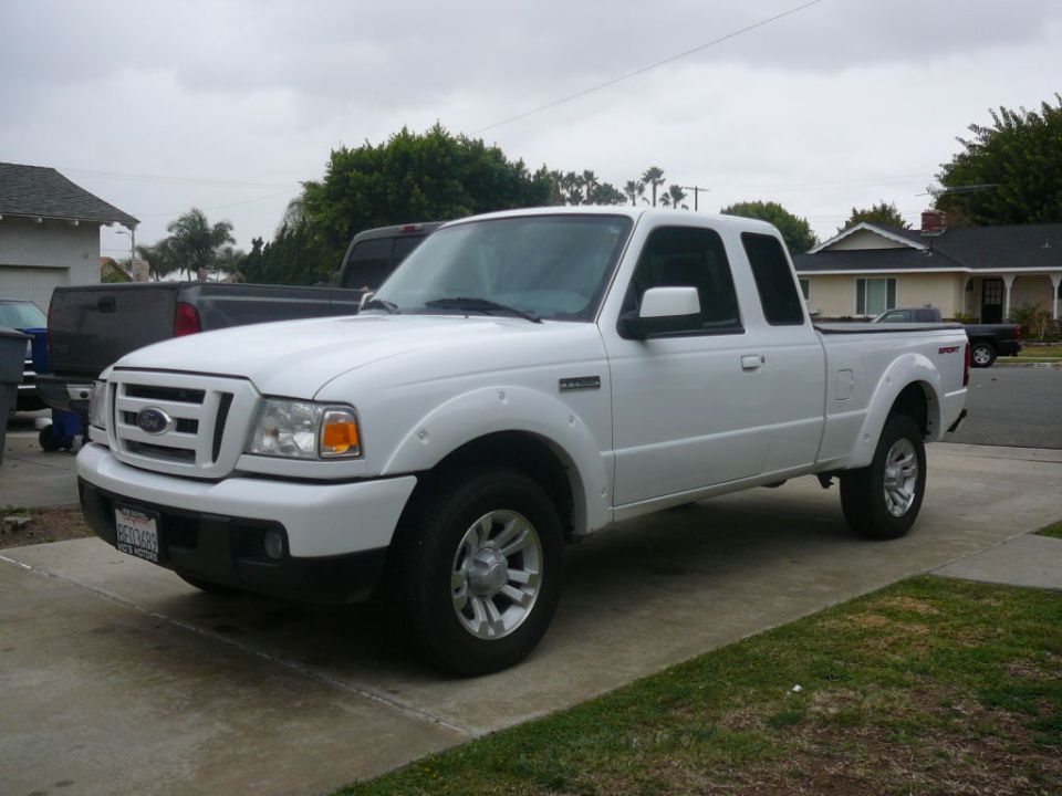 White Ford Ranger pickup truck, 3/4 front view, parked on a driveway
