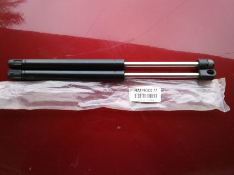 1998 Ford Crown Victoria - Pair of hood struts, part number F8AZ-16C826-AA, shown on a red surface.