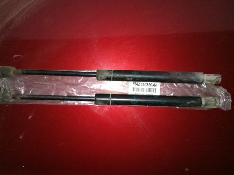 1998 Ford Crown Victoria - Pair of hood struts, part number F8AZ 16C826-AA, shown in packaging.
