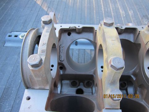 1969 Ford Mustang - Close-up of an engine crankshaft bearing housing, showing cast-in markings and bolts.