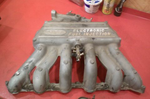 1987 Ford Bronco - Intake manifold for Ford electronic fuel injection system, showing the Ford logo and text.