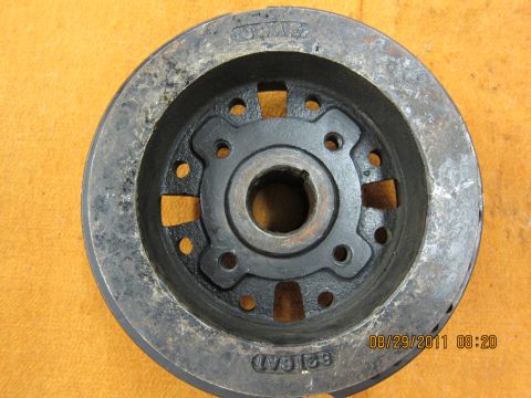 1969 Ford Mustang - A close-up view of a metal automotive part, likely a pulley or flywheel, with visible markings and wear.
