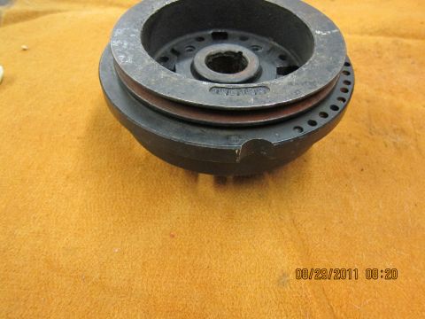 1969 Ford Mustang - Close-up of a crankshaft pulley, likely for an older vehicle, with visible part markings.