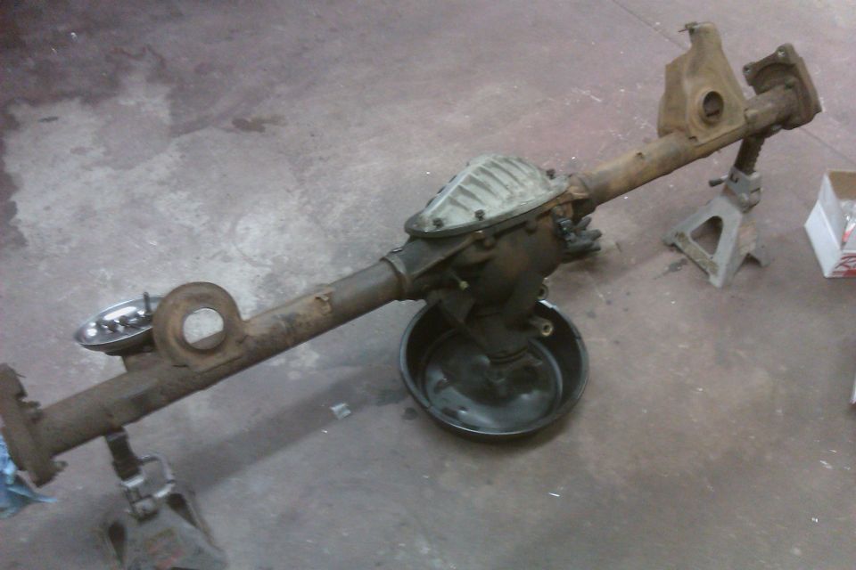 Rear axle assembly on jack stands with a drain pan underneath