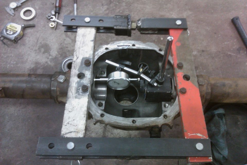 Differential housing with dial indicator and other tools set up for measurement