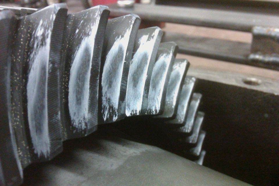 Close-up of gear teeth with white compound on them