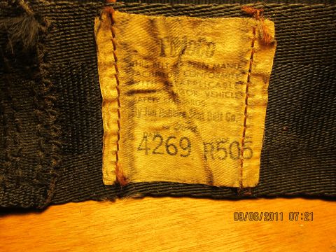1969 Ford Mustang - Close-up of a sewn-on label with part numbers and text, likely from a vehicle component.