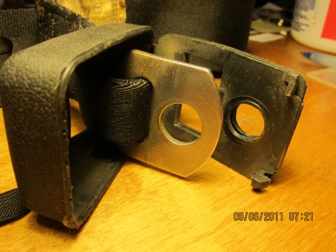 1969 Ford Mustang - A seatbelt buckle and strap are shown in detail, with a timestamp and website visible in the corner.