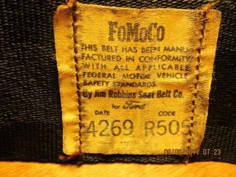 1969 Ford Mustang - This tag indicates the seat belt was manufactured by Jim Robbins Seat Belt Co. for Ford, adhering to federal safety standards.