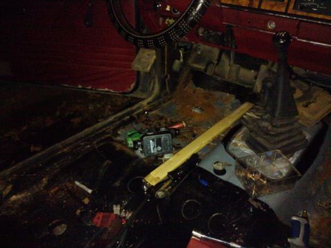 1988 Ford Ranger - The interior of a vehicle shows significant disrepair with exposed metal and debris on the floor.