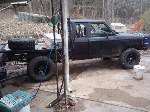 1988 Ford Ranger - This 1988 Ford Ranger pickup truck features a flatbed and oversized tires, suggesting off-road or work use.
