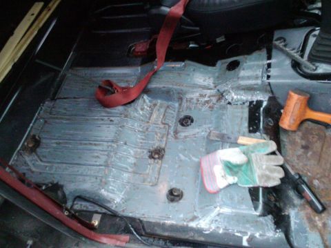 1988 Ford Ranger - The bare metal floor of a vehicle interior is visible, with tools laid out for work.