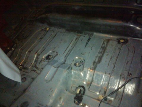 1988 Ford Ranger - The bare metal floor of a vehicle's interior is visible, with numerous mounting points and structural supports.
