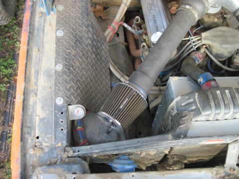 1978 Ford Bronco - Close-up view of an engine bay, highlighting an aftermarket air intake system and various engine components.