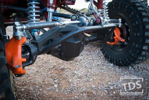 Suzuki Samurai - This image shows the custom suspension and drivetrain components of a modified off-road vehicle.