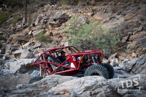 Suzuki Samurai - A custom-built red off-road buggy tackles a challenging rocky trail.