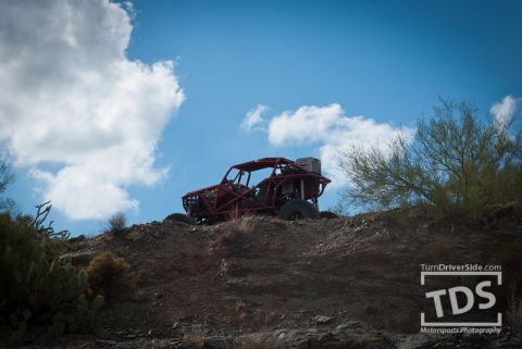 Suzuki Samurai - Off-road buggy with roll cage parked on a desert hill.