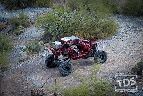 Suzuki Samurai - A custom-built off-road buggy navigates a rocky desert trail.