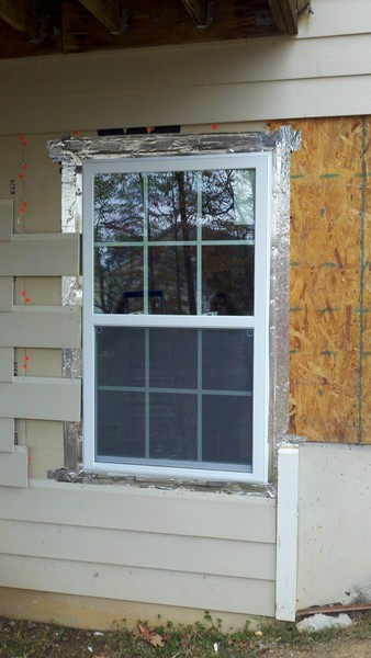 1995 Ford Bronco - Exterior window installation in progress, showing insulation and siding.