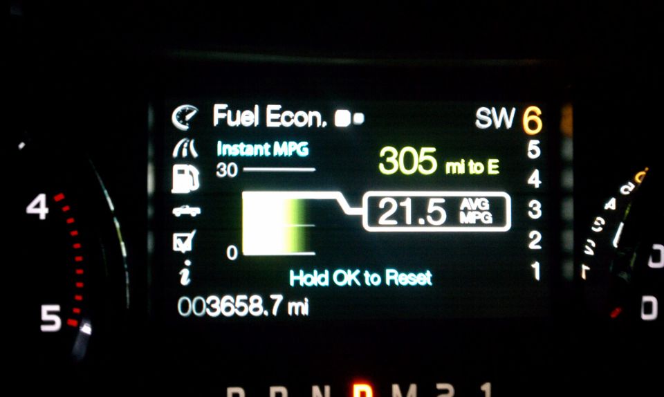 Digital dashboard showing fuel economy, instant MPG, 305 miles to empty, and 21.5 average MPG