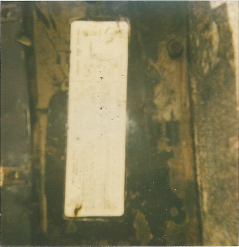 1978 Pontiac Trans Am - A close-up of a dirty vehicle component with a white plate, showing some unreadable text.