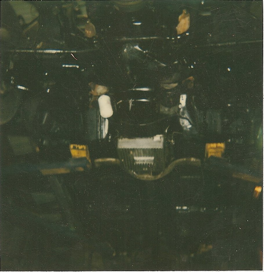 Underside view of a dark engine bay with some components visible