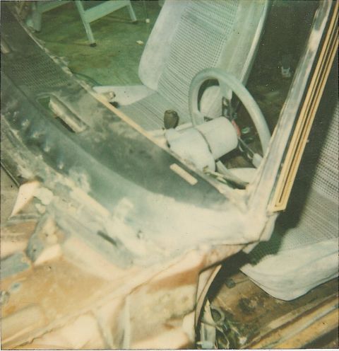 1978 Pontiac Trans Am - The interior of a car is shown with the dashboard disassembled, revealing the steering column and seats.