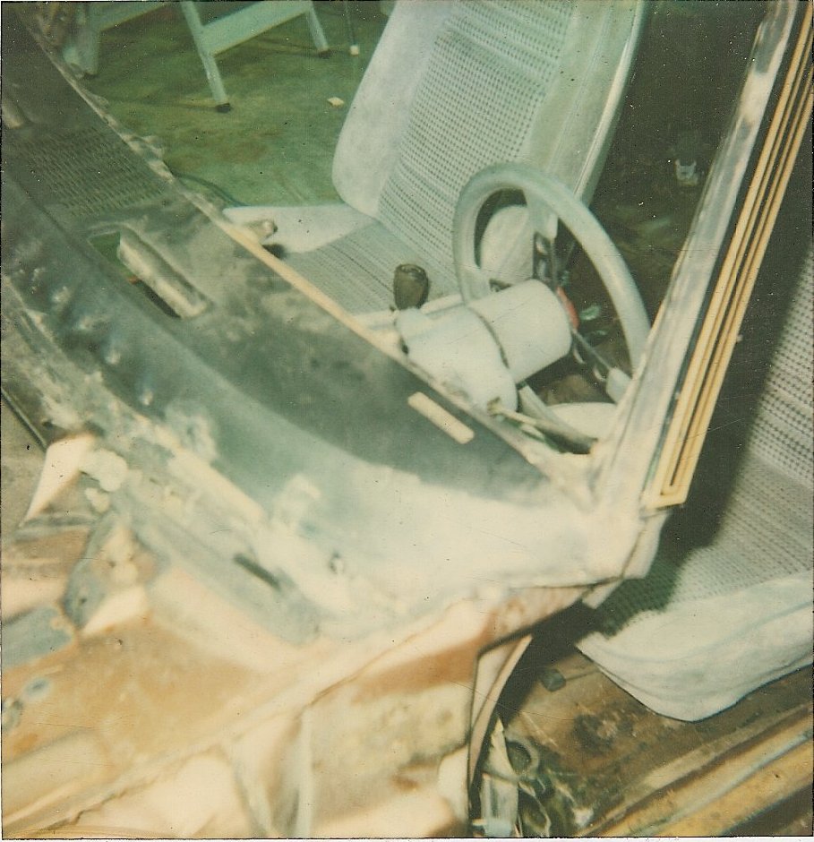 Car interior with dashboard removed, showing seats and steering wheel