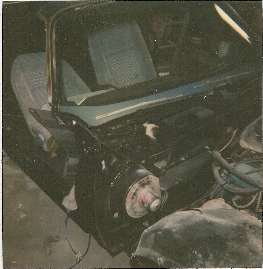 Interior and engine bay of a 1978 Pontiac Trans Am, showing blue patterned seats and exposed engine components