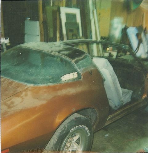 1978 Pontiac Trans Am - A dusty 1977 Firebird coupe sits in a garage with its driver's side door open.