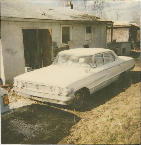 1978 Pontiac Trans Am - A faded polaroid shows a vintage white sedan parked in a grassy yard next to a weathered building.