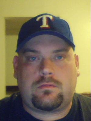1989 Ford Bronco - A man with a goatee and a baseball cap is shown in this close-up photo.