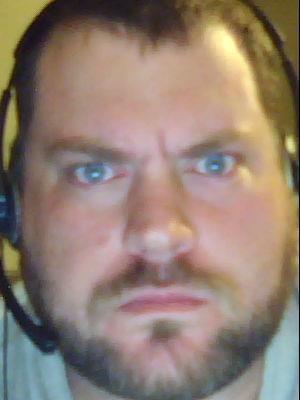 1989 Ford Bronco - A man with a headset and a stern expression is shown close-up, with website text at the bottom.