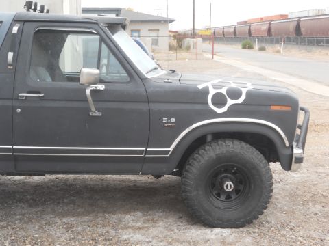 1986 Ford Bronco - Side view of a 1986 Ford Bronco, showing its body style and aftermarket modifications.