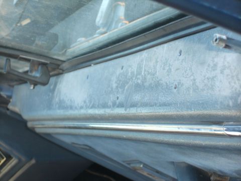 1986 Ford Bronco - Close-up of a vehicle's interior panel, showing texture and trim details.